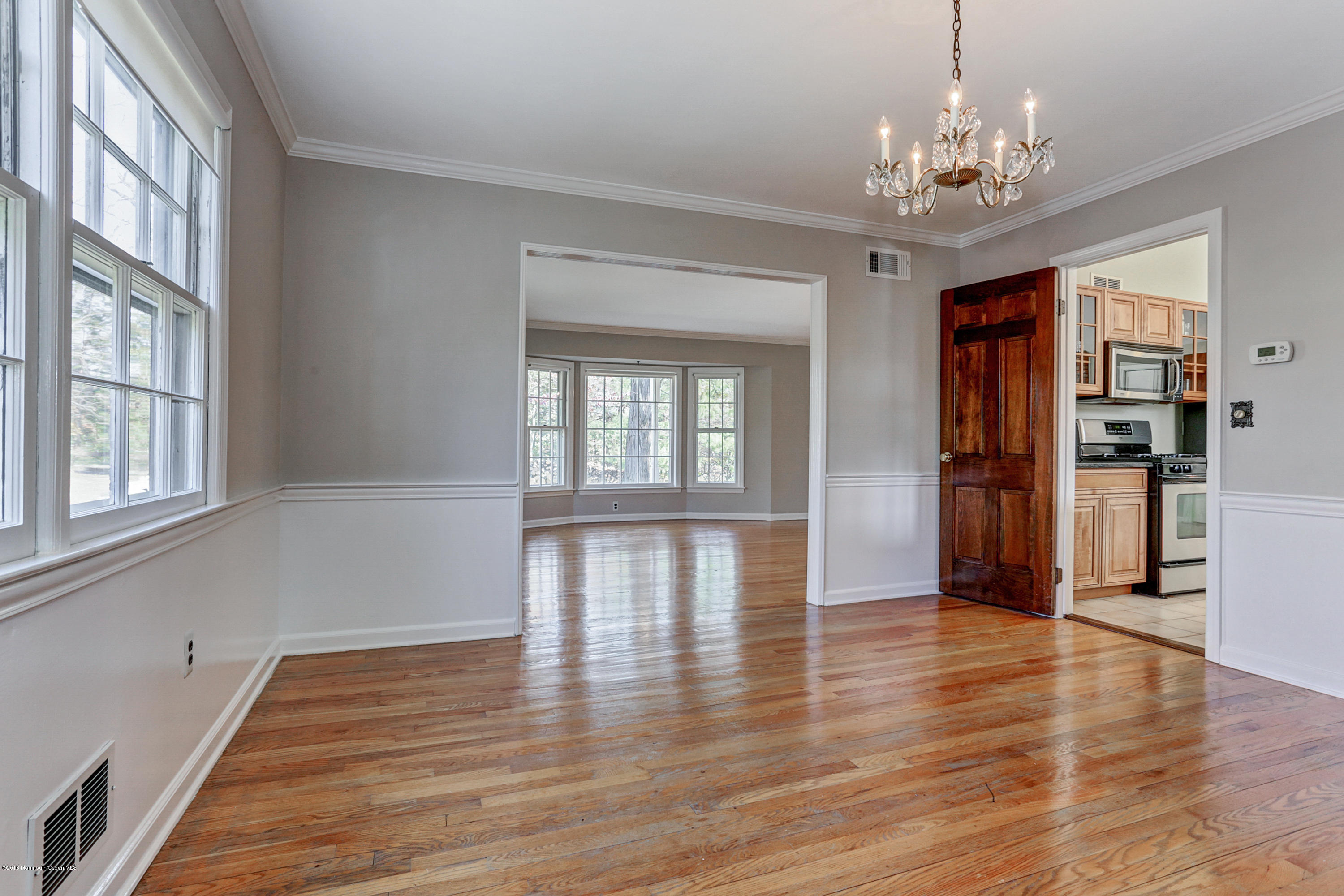 254 Newman Springs Road Colts Neck, NJ 07722 - Photo 8 of 30 a view of an empty room with wooden floor and a window