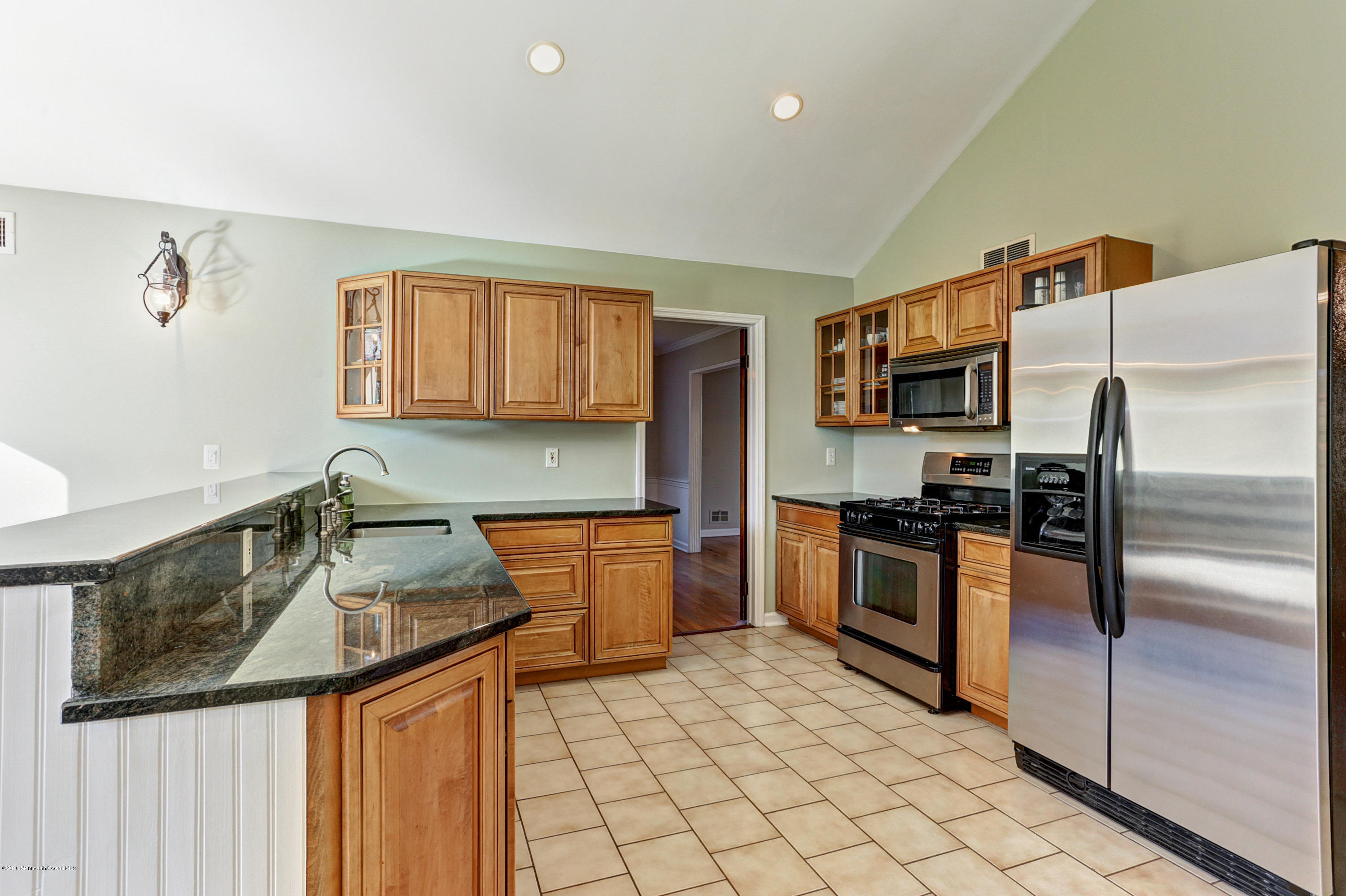 254 Newman Springs Road Colts Neck, NJ 07722 - Photo 9 of 30 a kitchen with stainless steel appliances granite countertop a sink stove and refrigerator