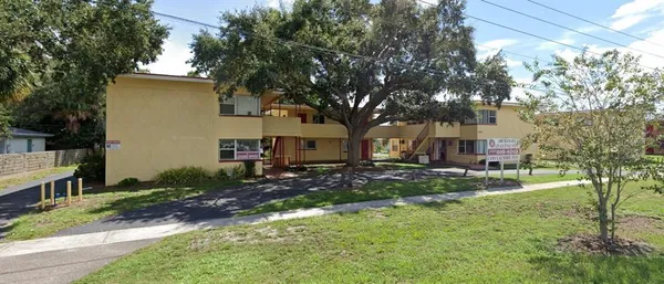 a view of a yard with a house and a tree
