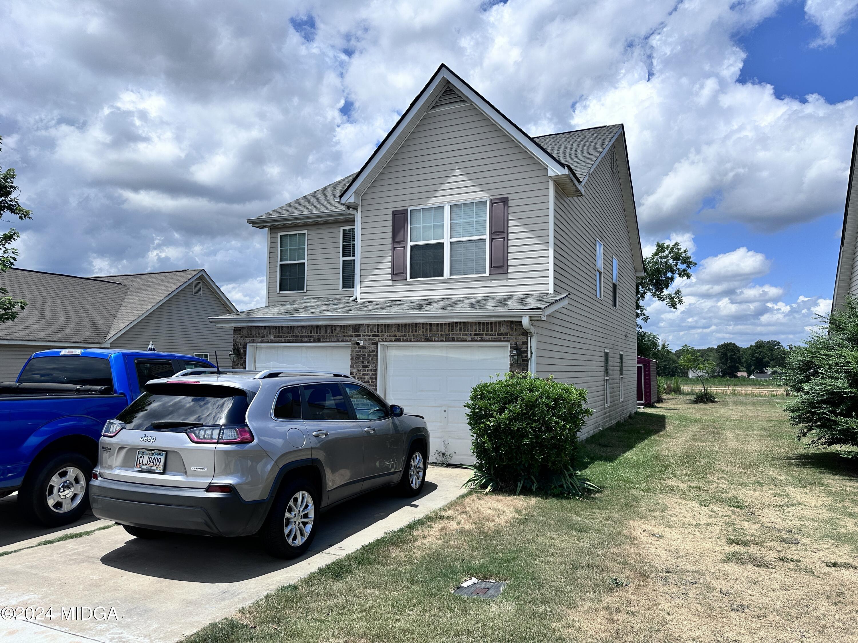 302 Arrie Drive Byron, GA 31008 - Photo 2 of 2 a car parked in front of a house