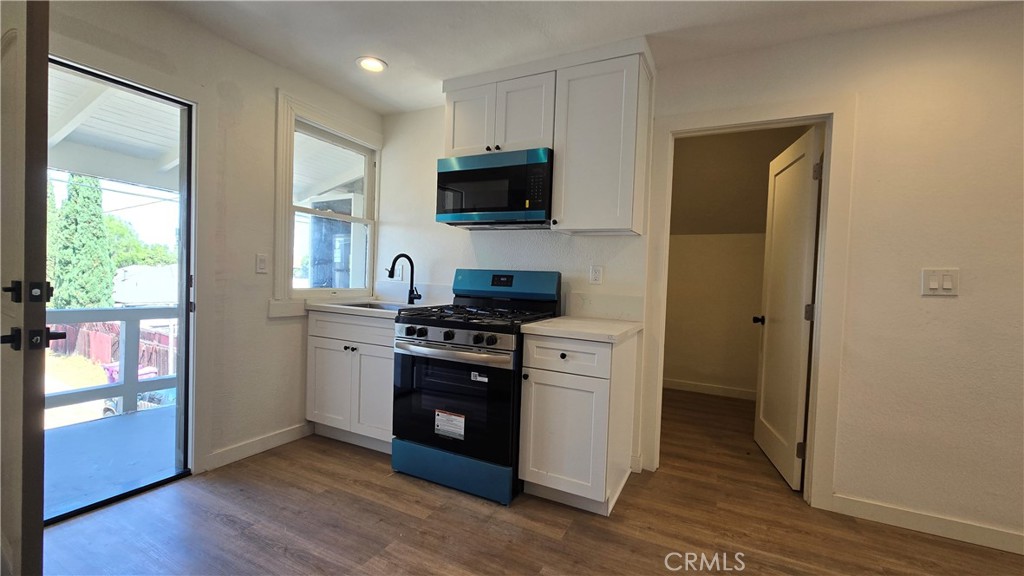 975 North Pk Circle, Unit B Long Beach, CA 90813 - Photo 5 of 9 a kitchen with stainless steel appliances granite countertop a stove a sink and a refrigerator