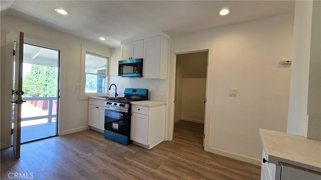 975 North Pk Circle, Unit B Long Beach, CA 90813 - Photo 6 of 9 a kitchen with stainless steel appliances a refrigerator and a stove top oven
