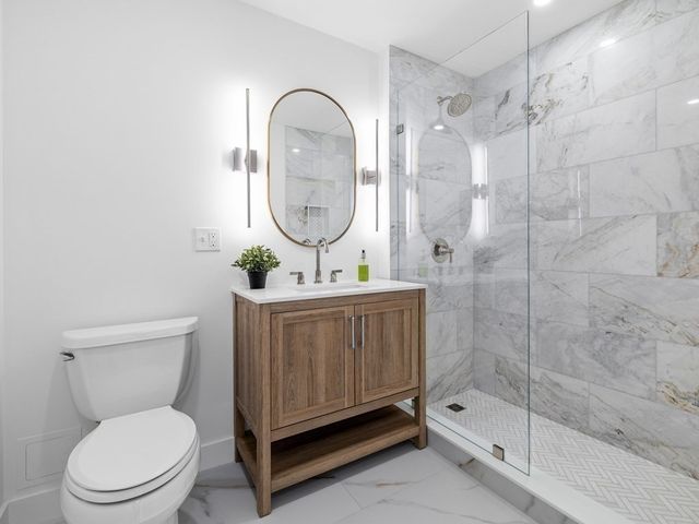 a bathroom with a toilet a sink and a shower