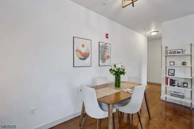 a kitchen with stainless steel appliances granite countertop white cabinets and a stove