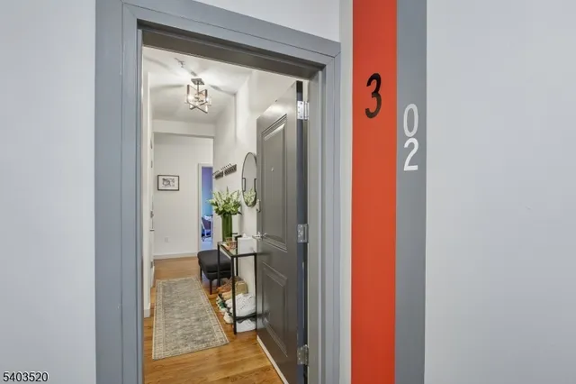 a living room with furniture kitchen view and a flat screen tv