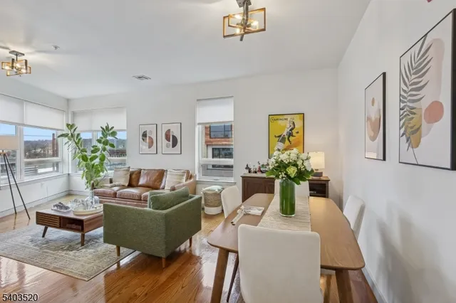 a living room with furniture kitchen view and a flat screen tv