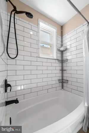 a bathroom with a bathtub and a shower