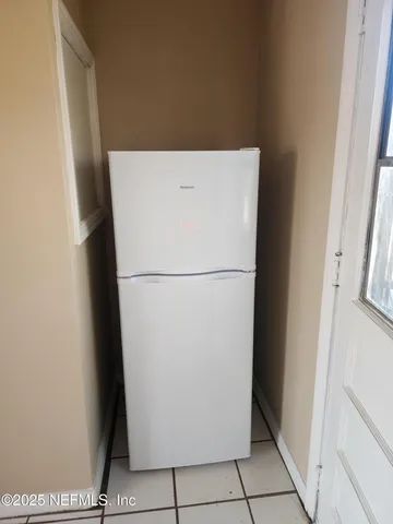 a view of a refrigerator in kitchen