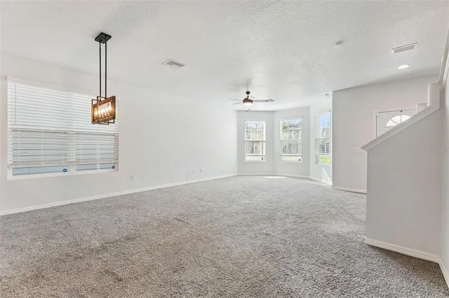 a view of a room with windows and ceiling fan