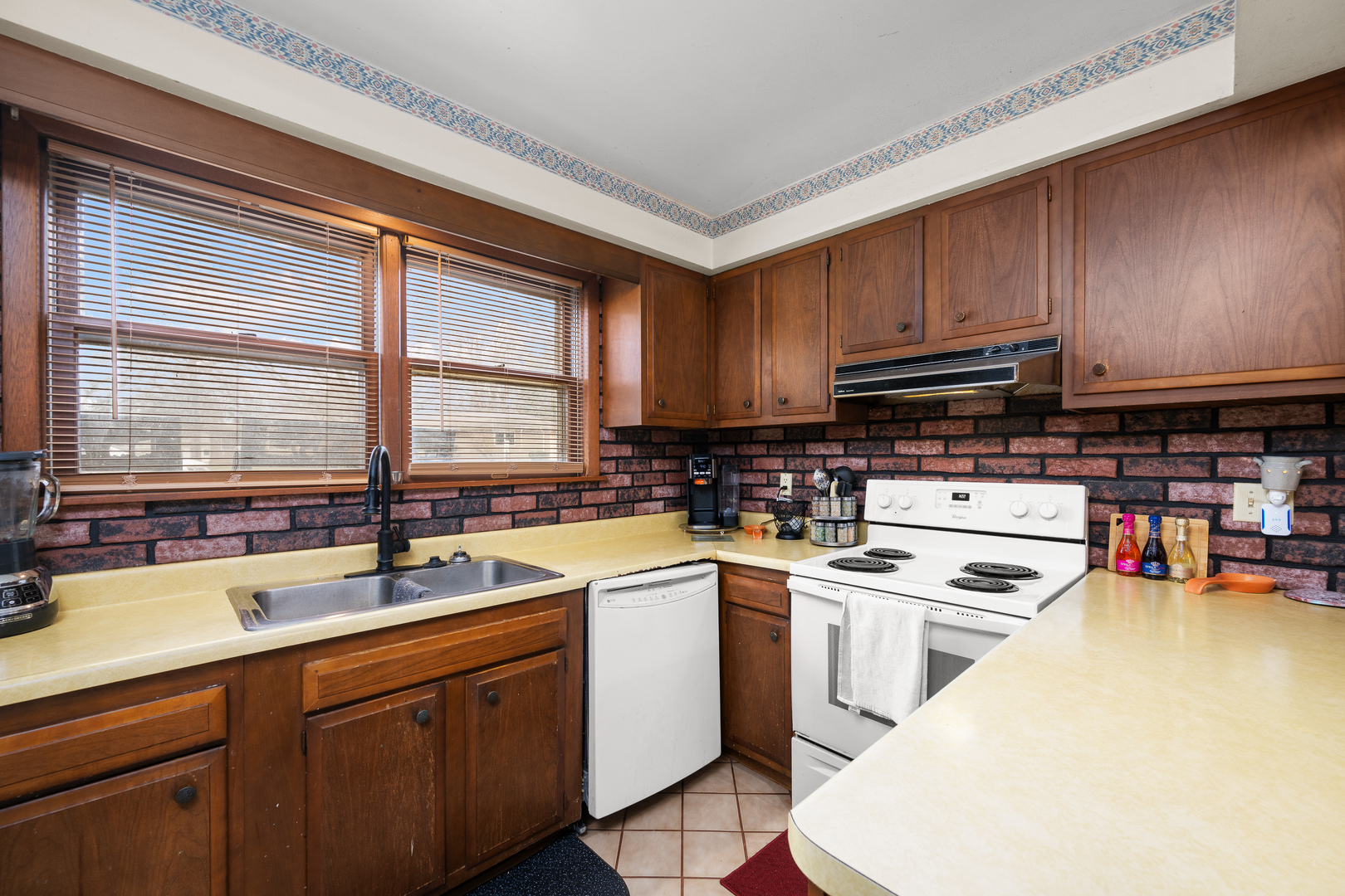 3604 32nd Avenue Moline, IL 61265 - Photo 12 of 36 a kitchen with stainless steel appliances a sink a stove and white cabinets