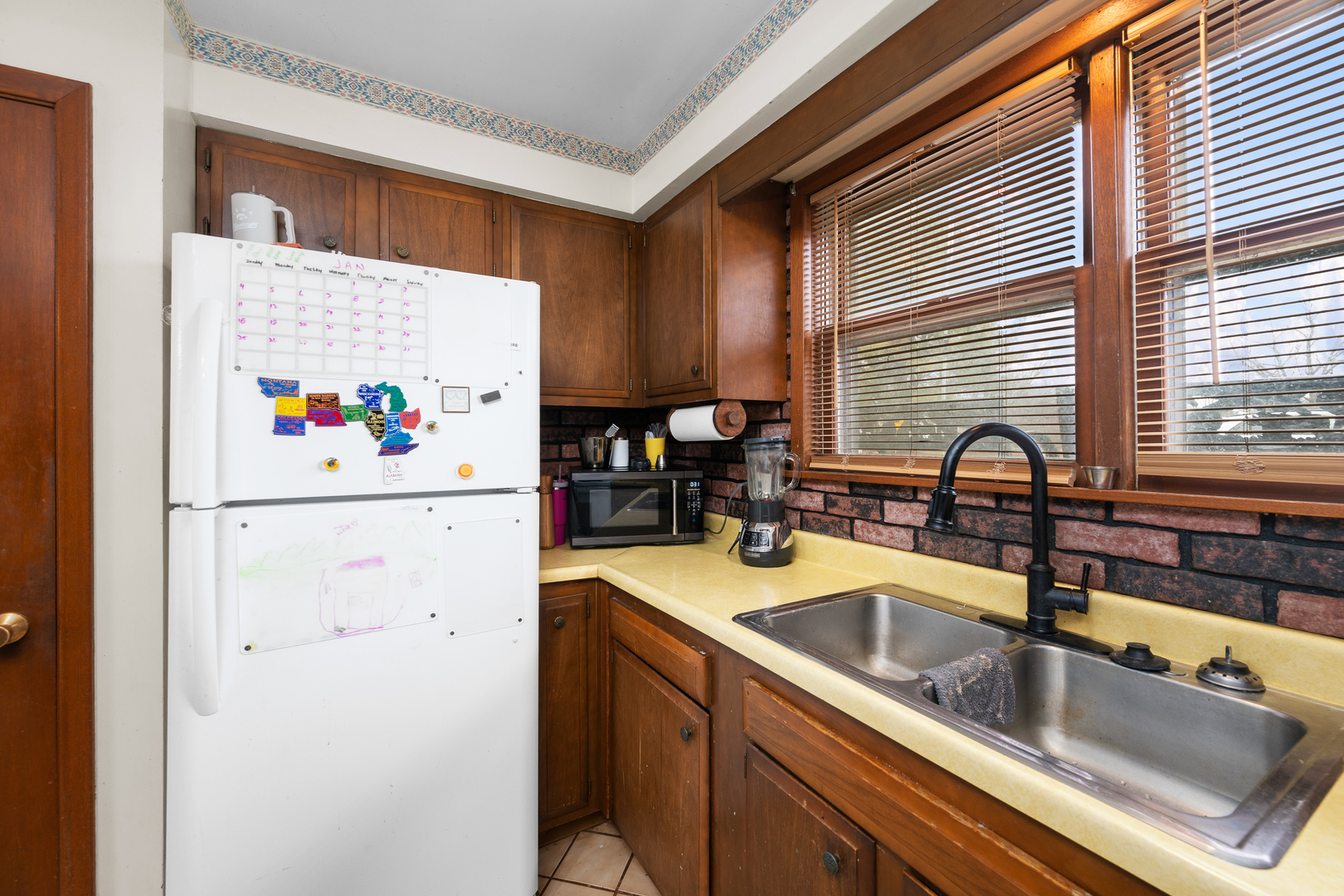3604 32nd Avenue Moline, IL 61265 - Photo 13 of 36 a kitchen with a sink a refrigerator and a window