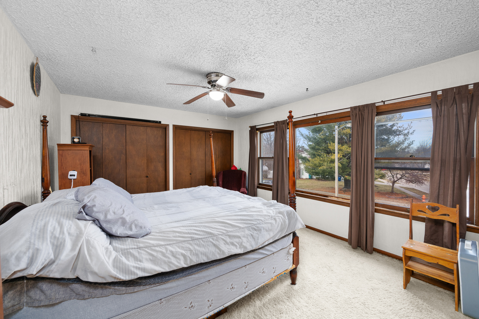 3604 32nd Avenue Moline, IL 61265 - Photo 17 of 36 a bedroom with a large bed and a chandelier