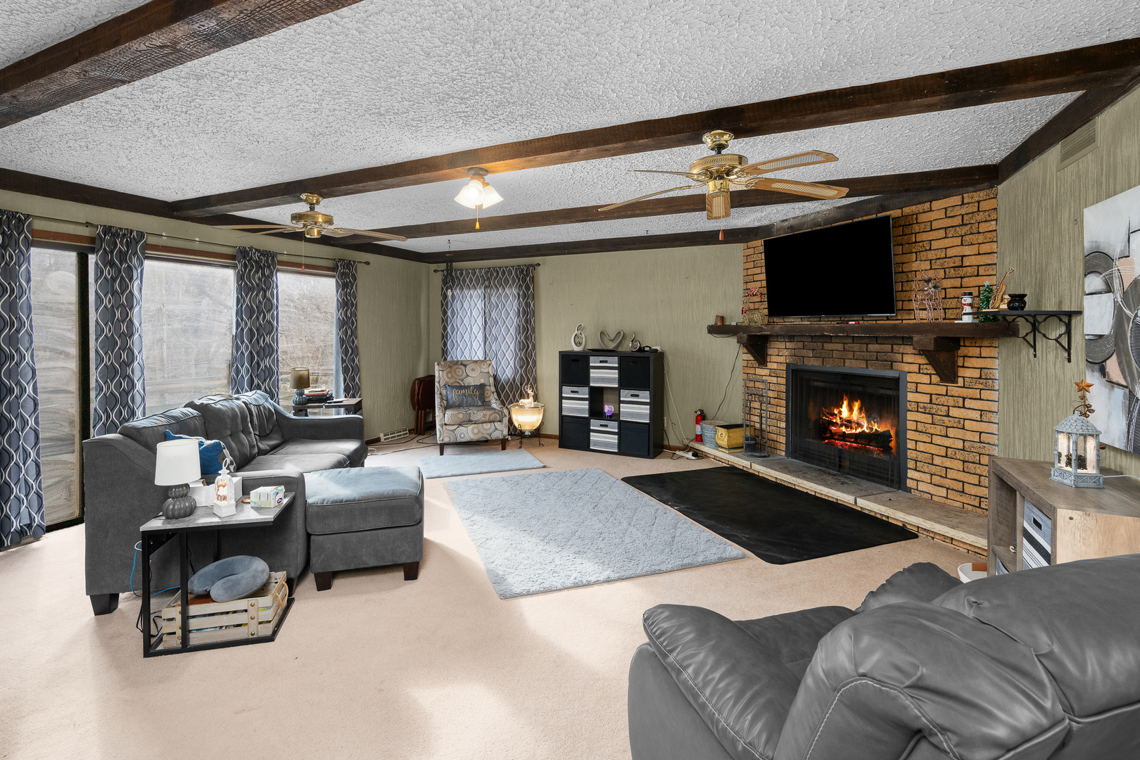 3604 32nd Avenue Moline, IL 61265 - Photo 7 of 36 a living room with furniture a flat screen tv and a fireplace