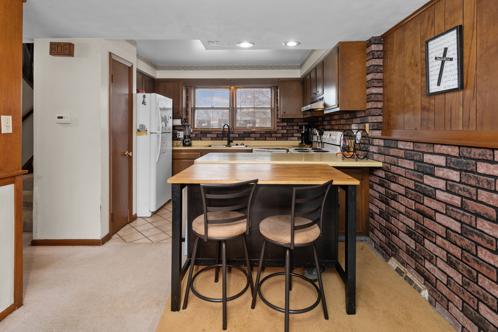 3604 32nd Avenue Moline, IL 61265 - Photo 10 of 36 a kitchen with stainless steel appliances a dining table chairs refrigerator and sink