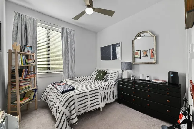 a bedroom with a bed and a painting on the wall