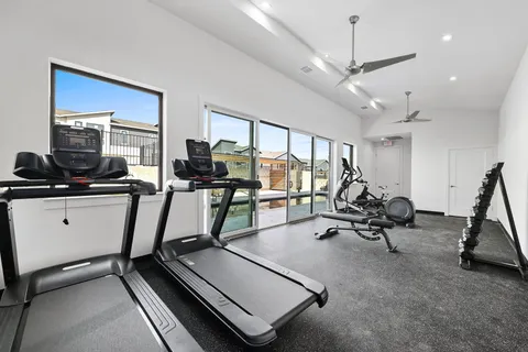 a room with gym equipment and a large window