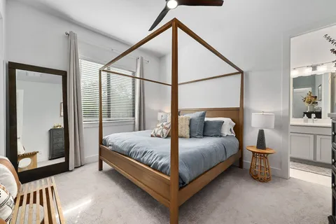 a bedroom with a bed and a mirror