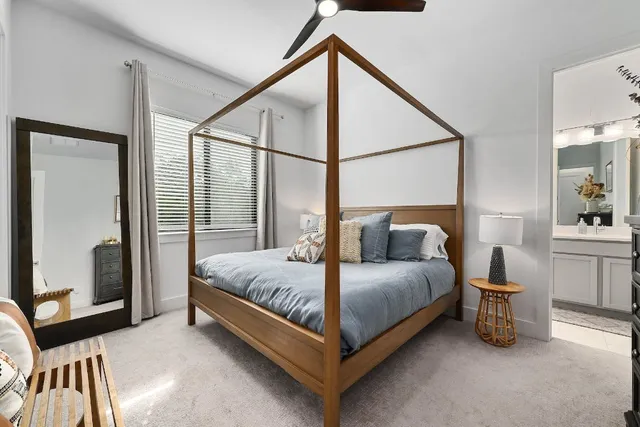 a bedroom with a bed and a mirror