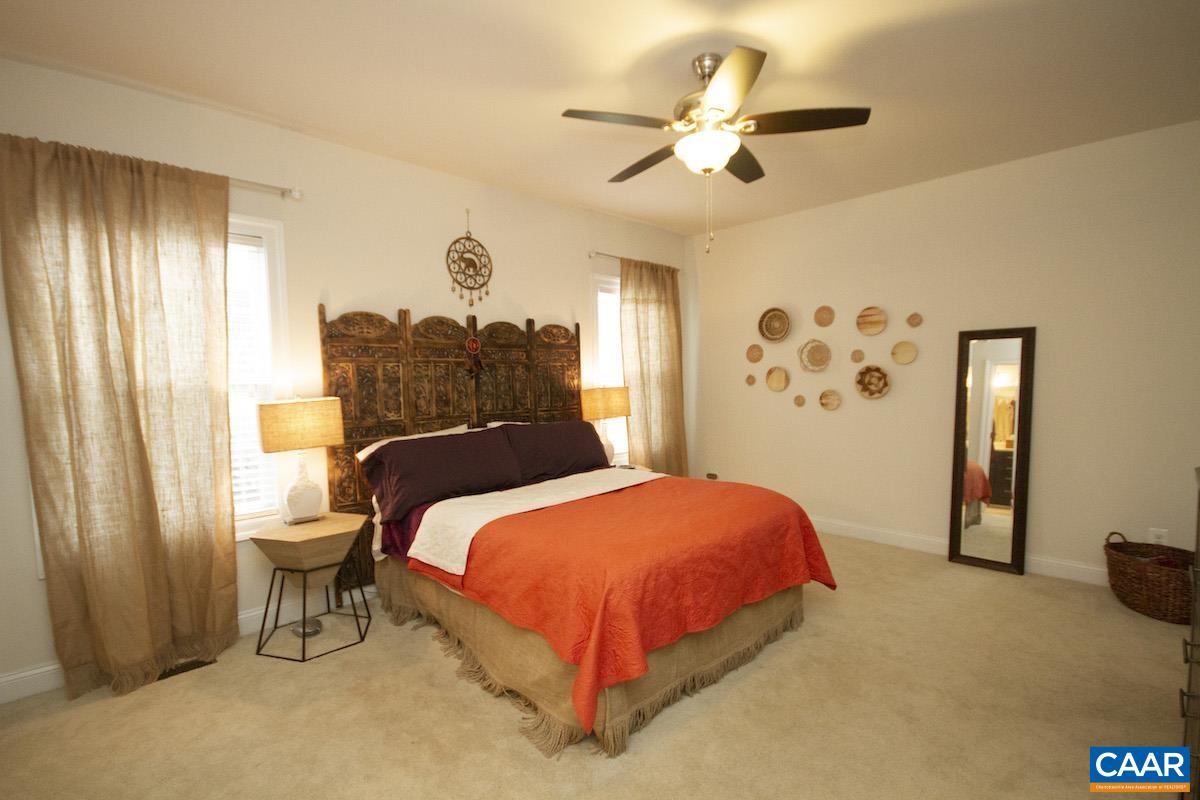2307 Avinity Court Charlottesville, VA 22902 - Photo 12 of 35 a bedroom with a bed and a chandelier