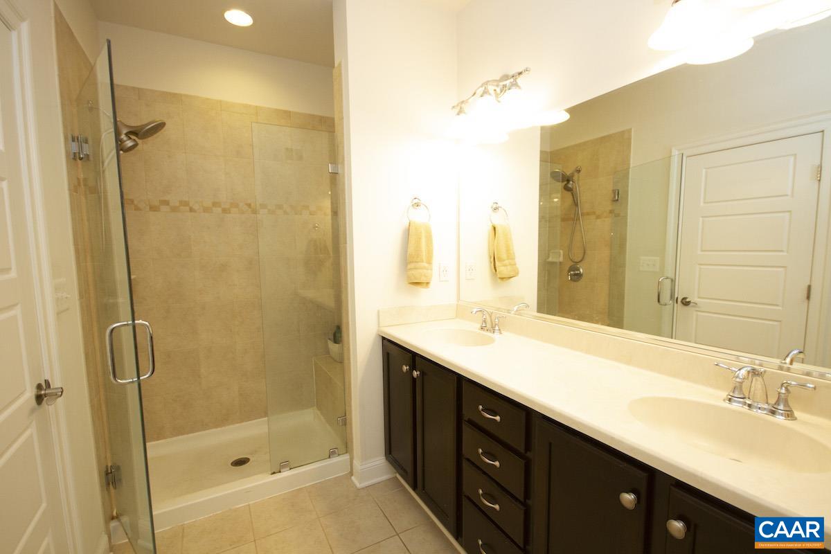 2307 Avinity Court Charlottesville, VA 22902 - Photo 13 of 35 a bathroom with a shower sink and mirror