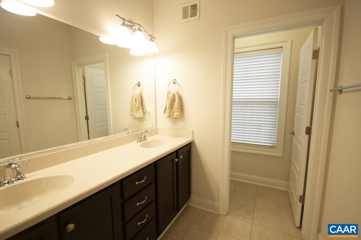 2307 Avinity Court Charlottesville, VA 22902 - Photo 14 of 35 a bathroom with a double vanity sink and a mirror