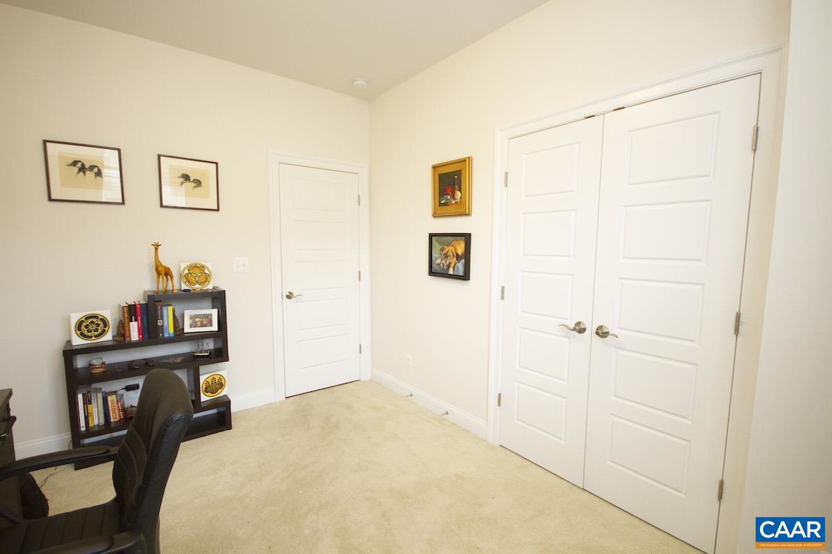 2307 Avinity Court Charlottesville, VA 22902 - Photo 16 of 35 a bed room with a bed and a book shelf