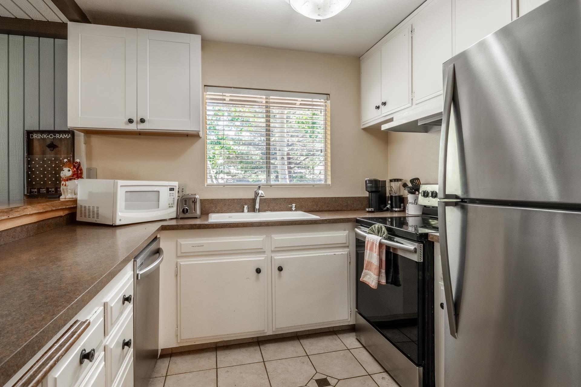 165 Old Mammoth Road, Unit 3 Mammoth Lakes, CA 93546 - Photo 13 of 48 Kitchen featuring white cabinetry, stainless steel appliances, a double basin sink, and tile flooring