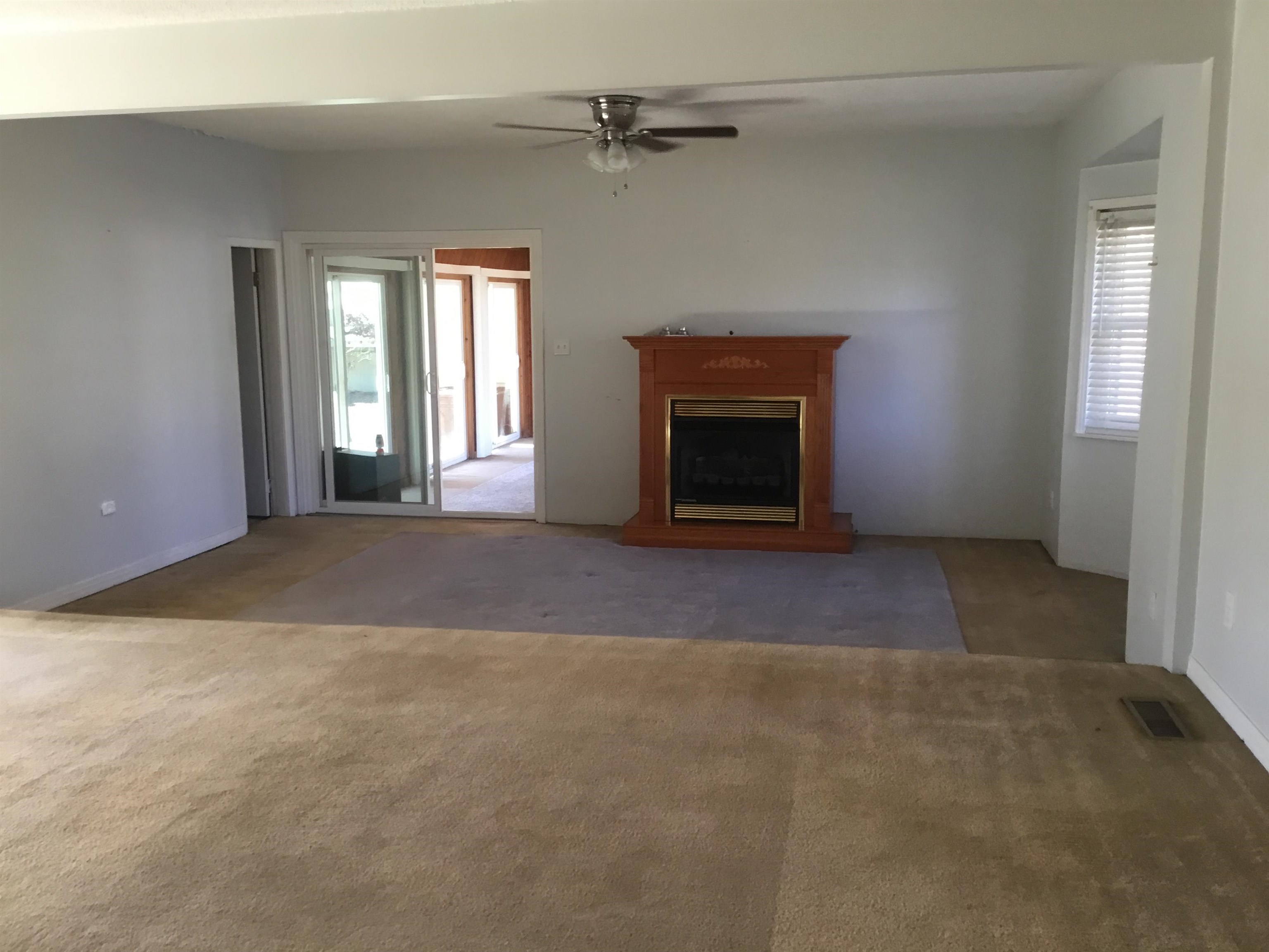 367 Crabtree Road Selmer, TN 38375 - Photo 2 of 23 an empty room with windows and fireplace