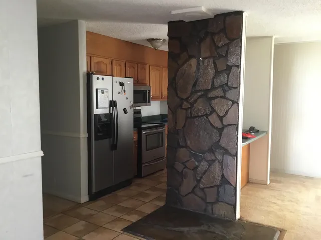 a refrigerator freezer sitting inside of a kitchen