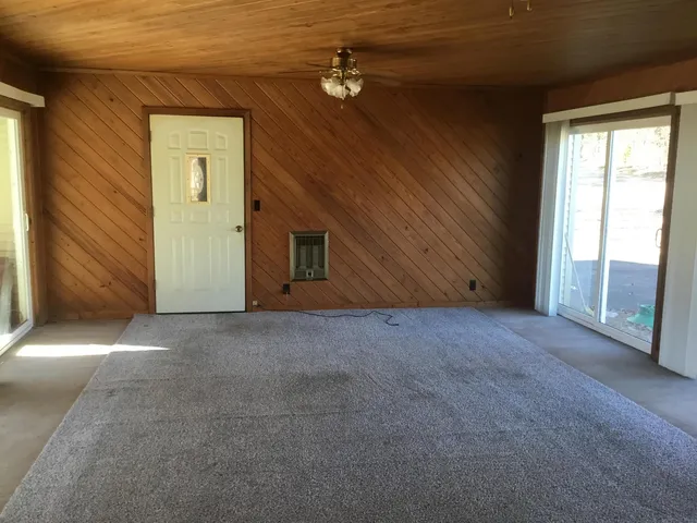 a view of a livingroom with a ceiling fan and window