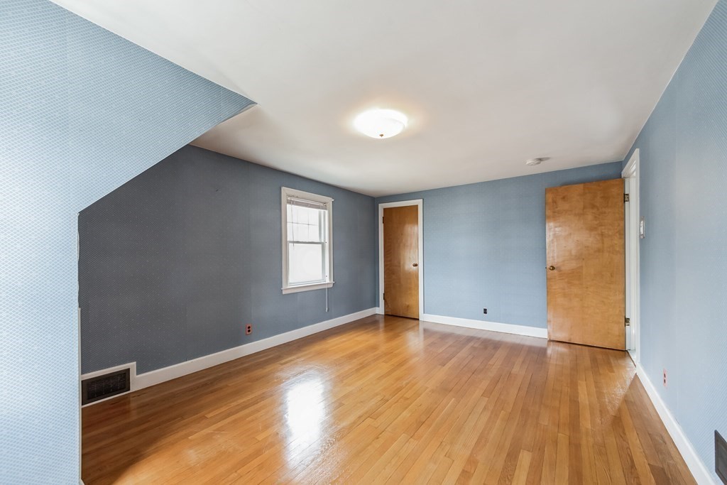 90 Lexington Road Billerica, MA 01821 - Photo 18 of 28 an empty room with wooden floor and windows