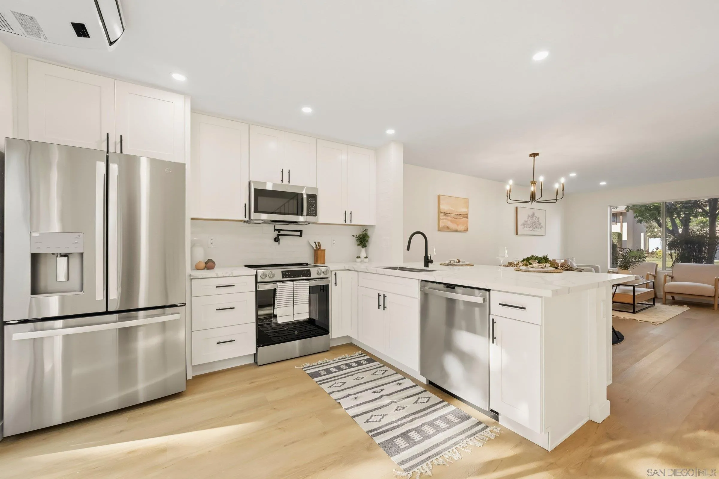 458 Ridgeway Court Spring Valley, CA 91977 - Photo 11 of 26 a kitchen with white cabinets and stainless steel appliances