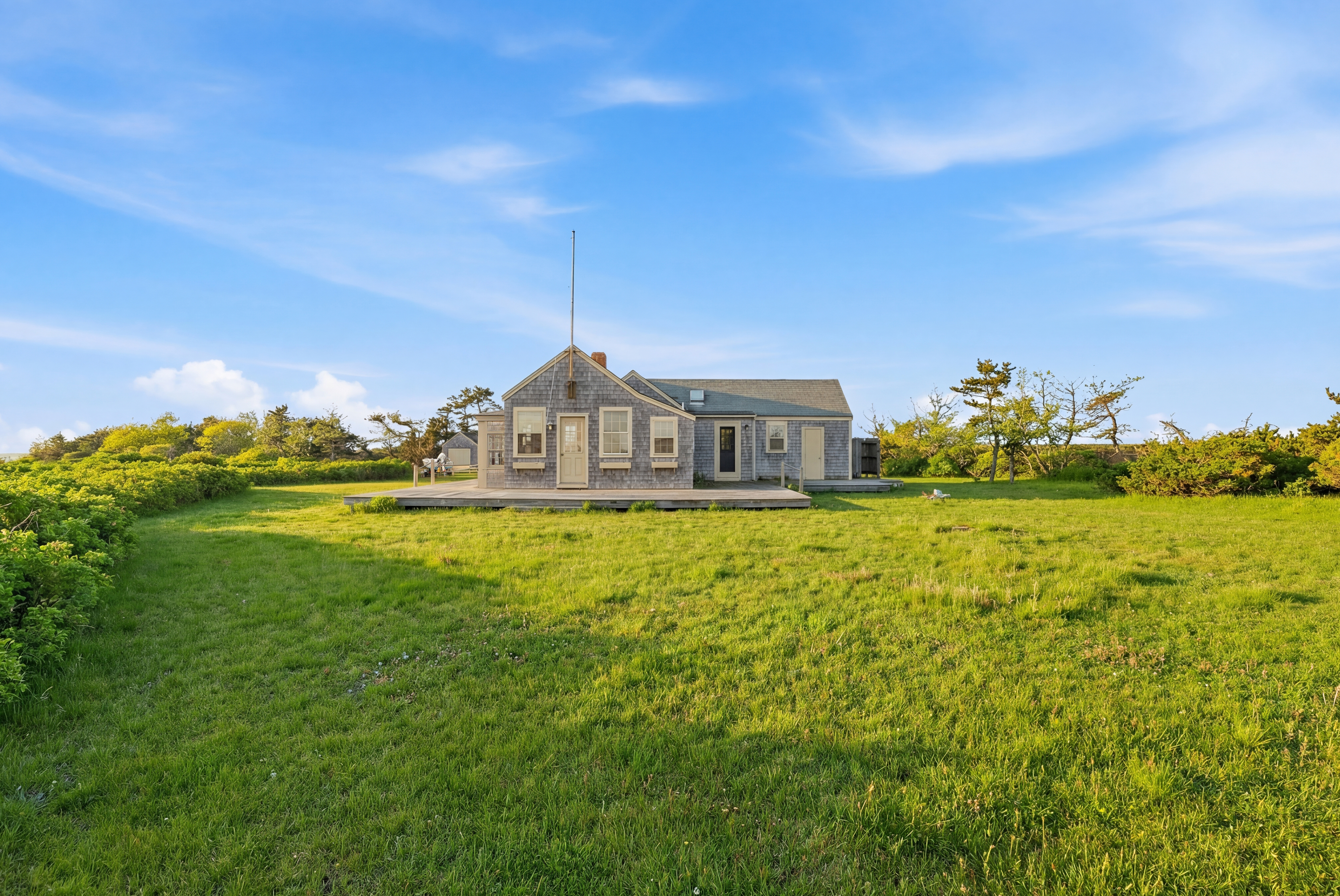 44 Madequecham Valley Road Nantucket, MA 02554 - Photo 10 of 19 a front view of a house with a garden