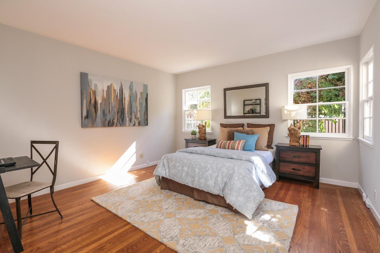 2160 Middlefield Road Palo Alto, CA 94301 - Photo 13 of 24 a spacious bedroom with a bed a dresser and wooden floor