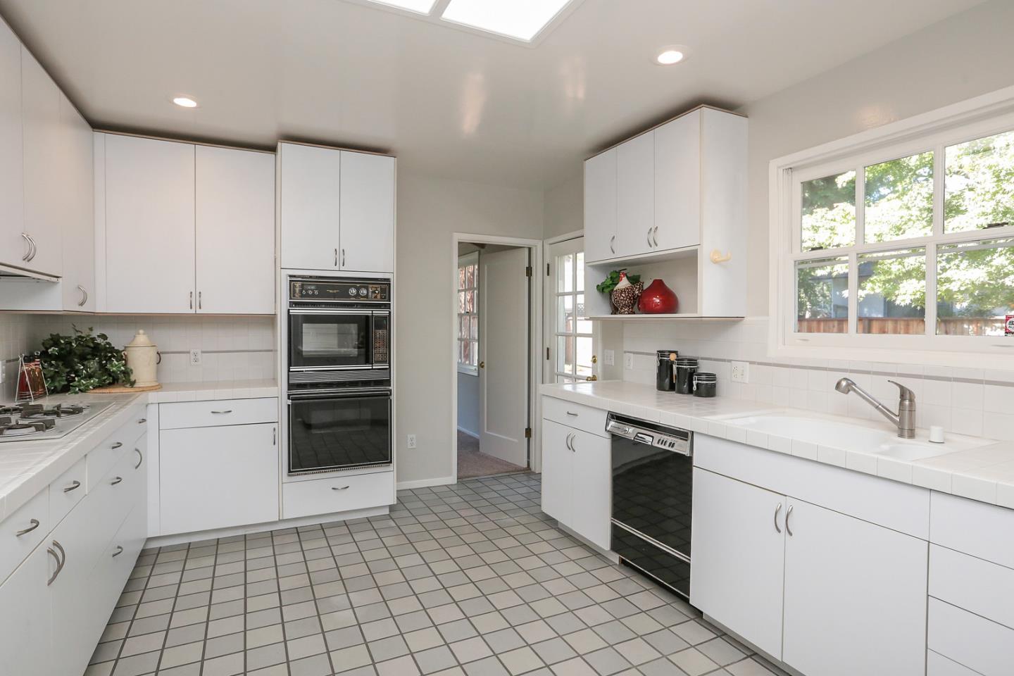 2160 Middlefield Road Palo Alto, CA 94301 - Photo 9 of 24 a kitchen with granite countertop white cabinets and white appliances
