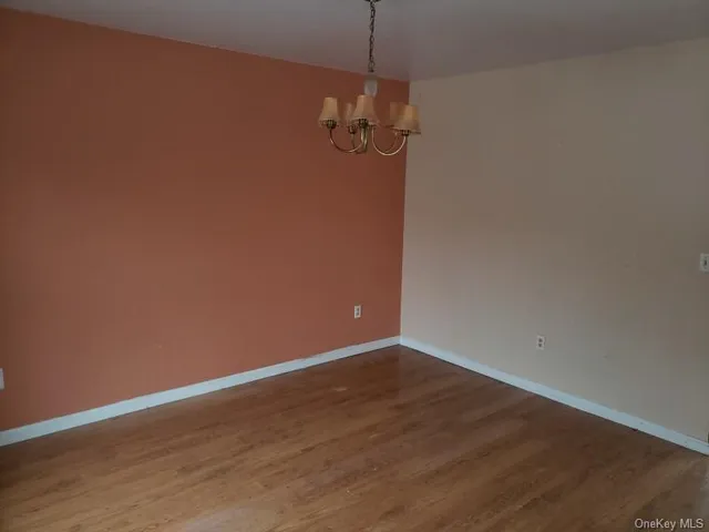 a view of a room with wooden floor and fan