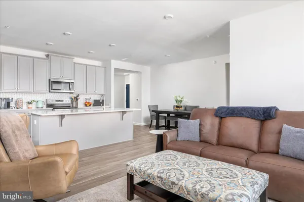 a living room with furniture and kitchen view
