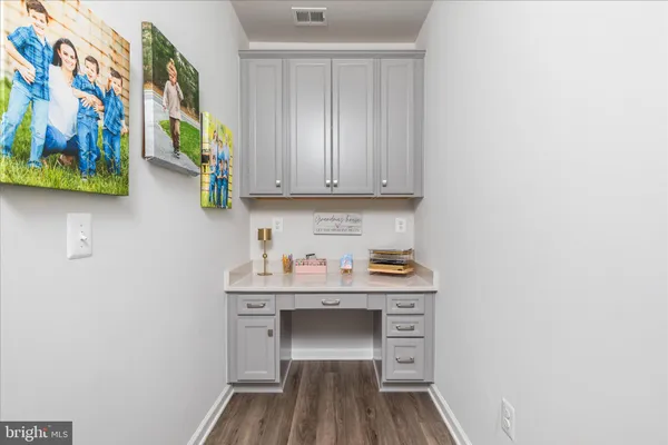a view of a room with wooden floor and cabinet