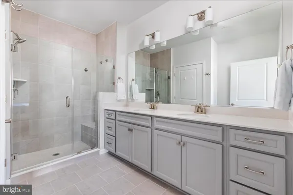 a bathroom with a shower sink and mirror