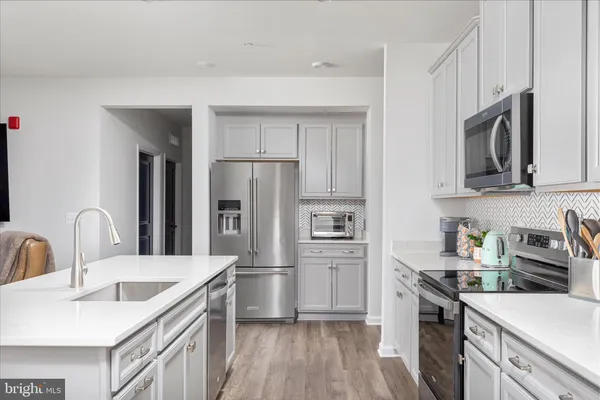 a kitchen with a sink stove and refrigerator