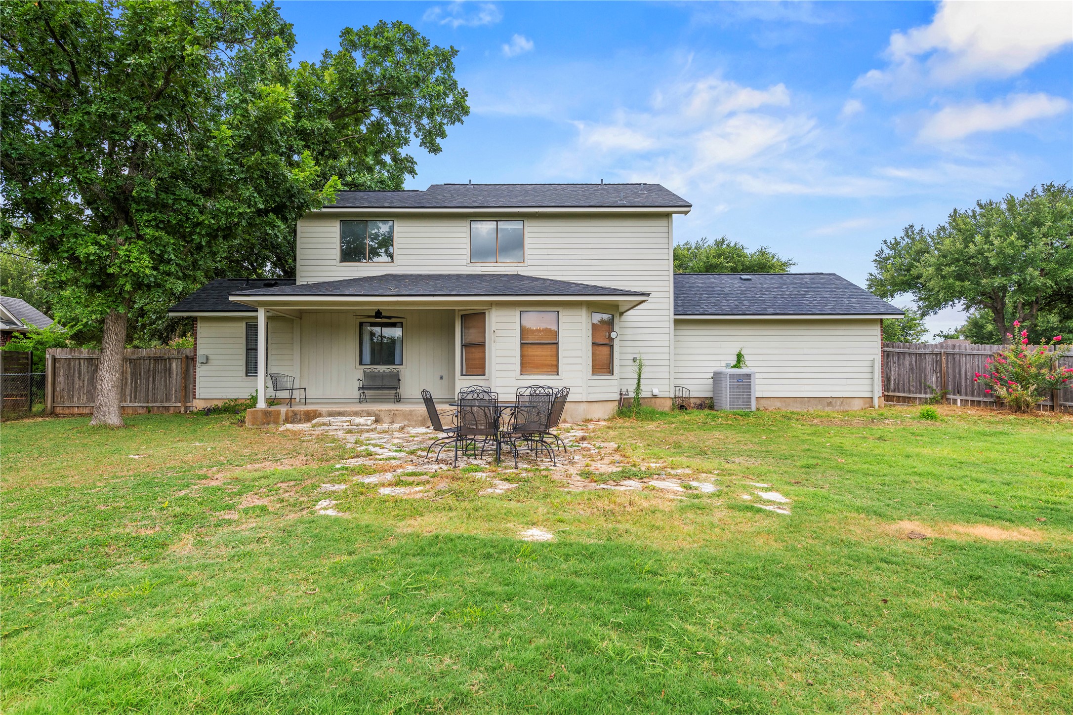1329 Quail Ravine Round Rock, TX 78664 - Photo 38 of 39 An expansive green lawn stretches toward the covered back patio of this two-story home.