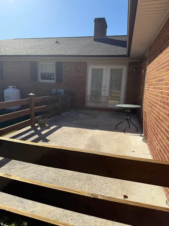 a view of a backyard with a table and chair