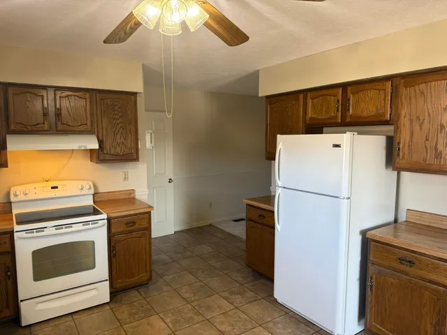 a view of an empty room with a fireplace