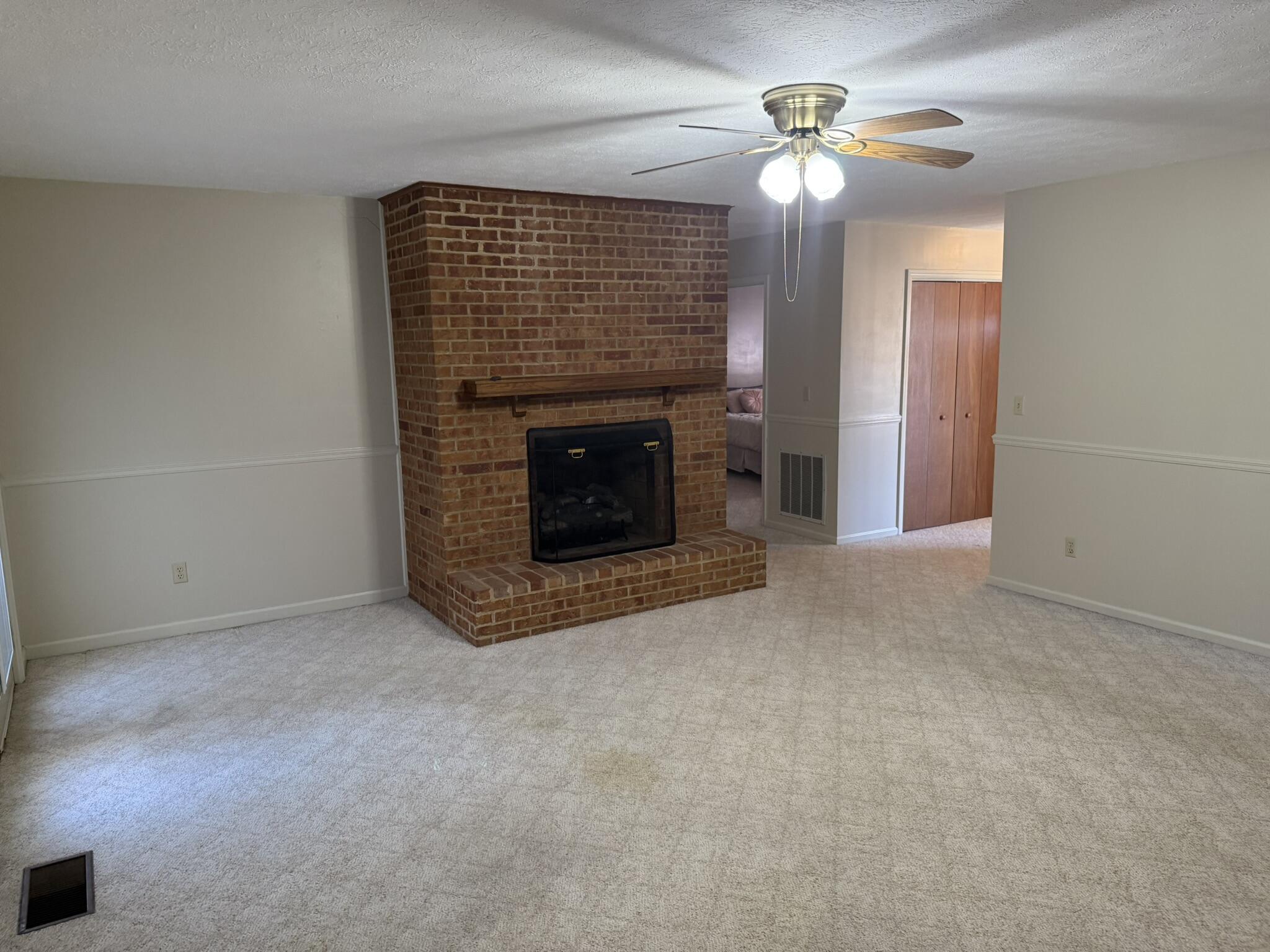 200 Sherry May Street Covington, VA 24426 - Photo 20 of 57 an empty room with fireplace and fan