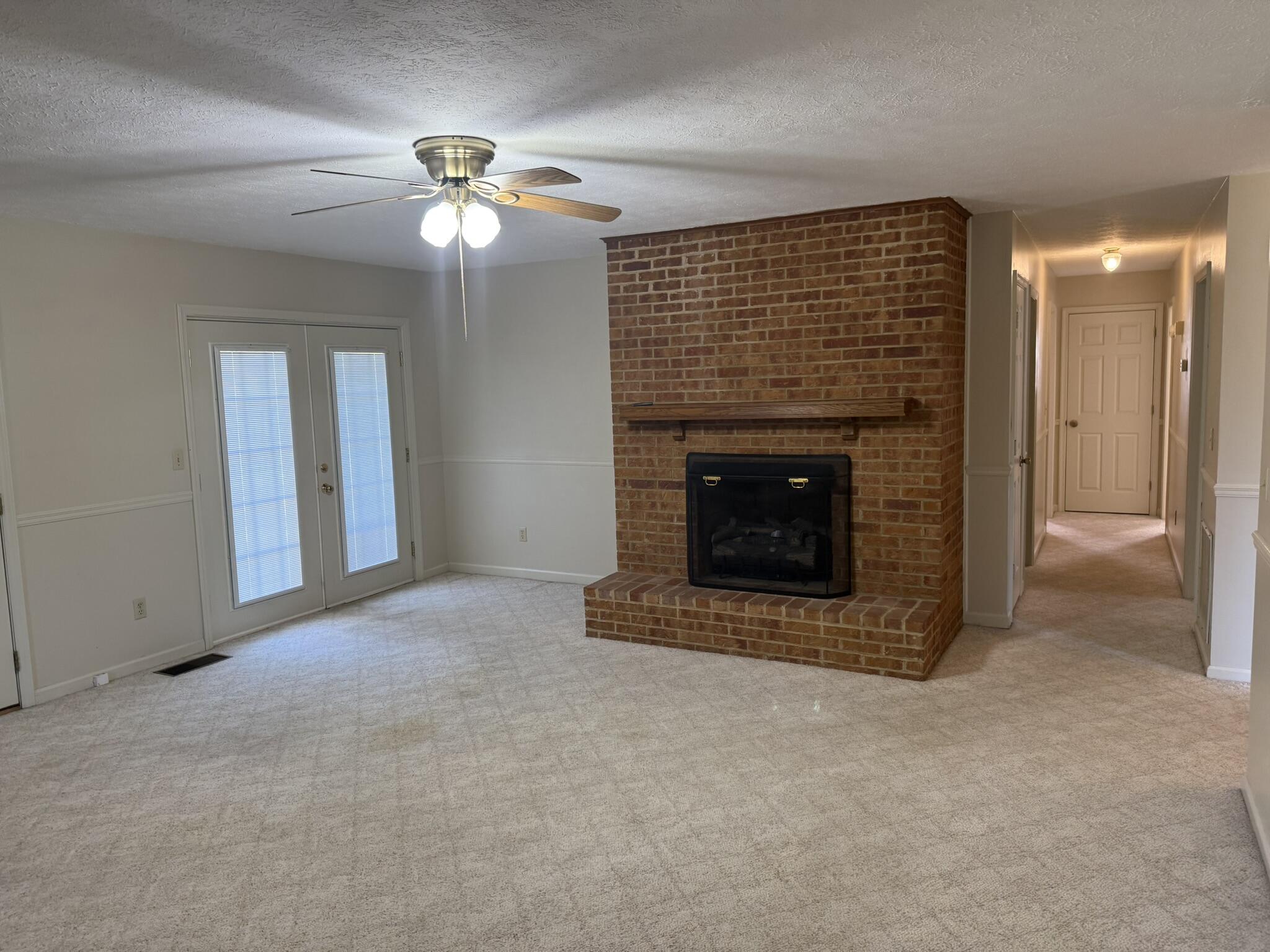 200 Sherry May Street Covington, VA 24426 - Photo 21 of 57 a view of an empty room with chandelier fan and fire place