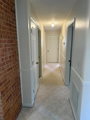 a bathroom with a granite countertop toilet and a sink