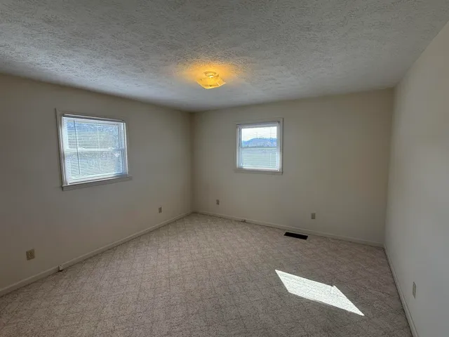 a bathroom with a granite countertop shower and a sink