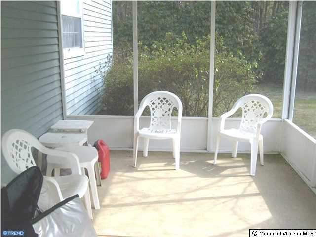 133B Sunset Road, Unit B Whiting, NJ 08759 - Photo 3 of 8 a front view of a house with dining table and chairs