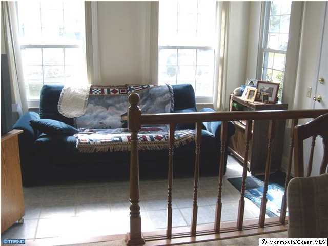 133B Sunset Road, Unit B Whiting, NJ 08759 - Photo 6 of 8 a bedroom with furniture and windows