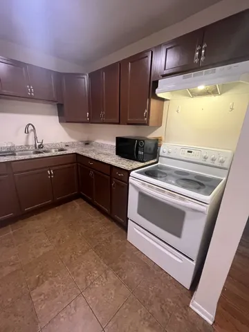 a bathroom with a granite countertop sink a mirror and vanity